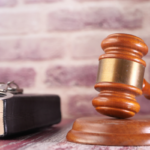 A picture of a Judges hammer and gavel next to a law book. I've used it to represent changes to legislation that Monzo is requesting.
