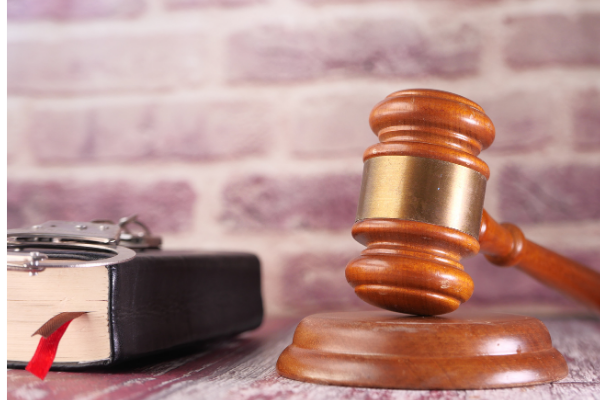 A picture of a Judges hammer and gavel next to a law book. I've used it to represent changes to legislation that Monzo is requesting.