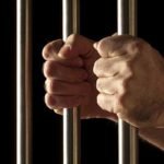 A man behind prison bars